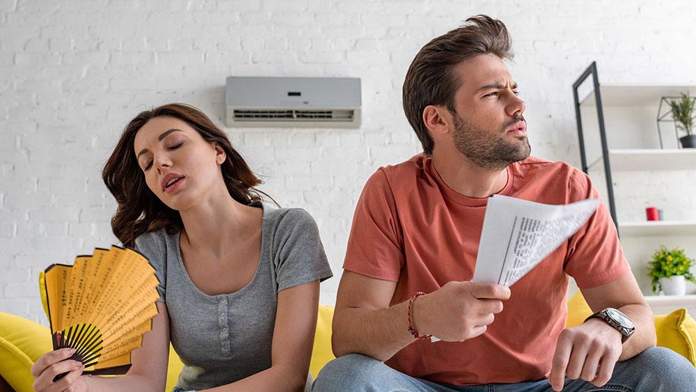 man and woman fanning their faces