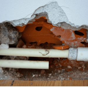 two exposed pipes in wall