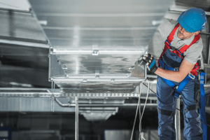 Technician Insulating Ductwork