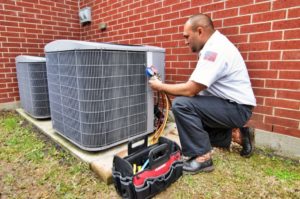technician maintaining AC