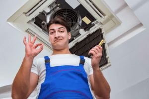 technician in front of air ducts