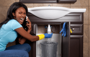 customer on phone while under sink drain leaks