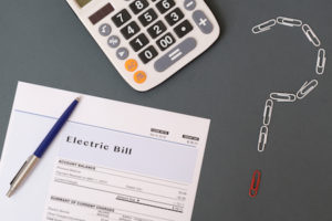 electric bill next to calculator and question mark